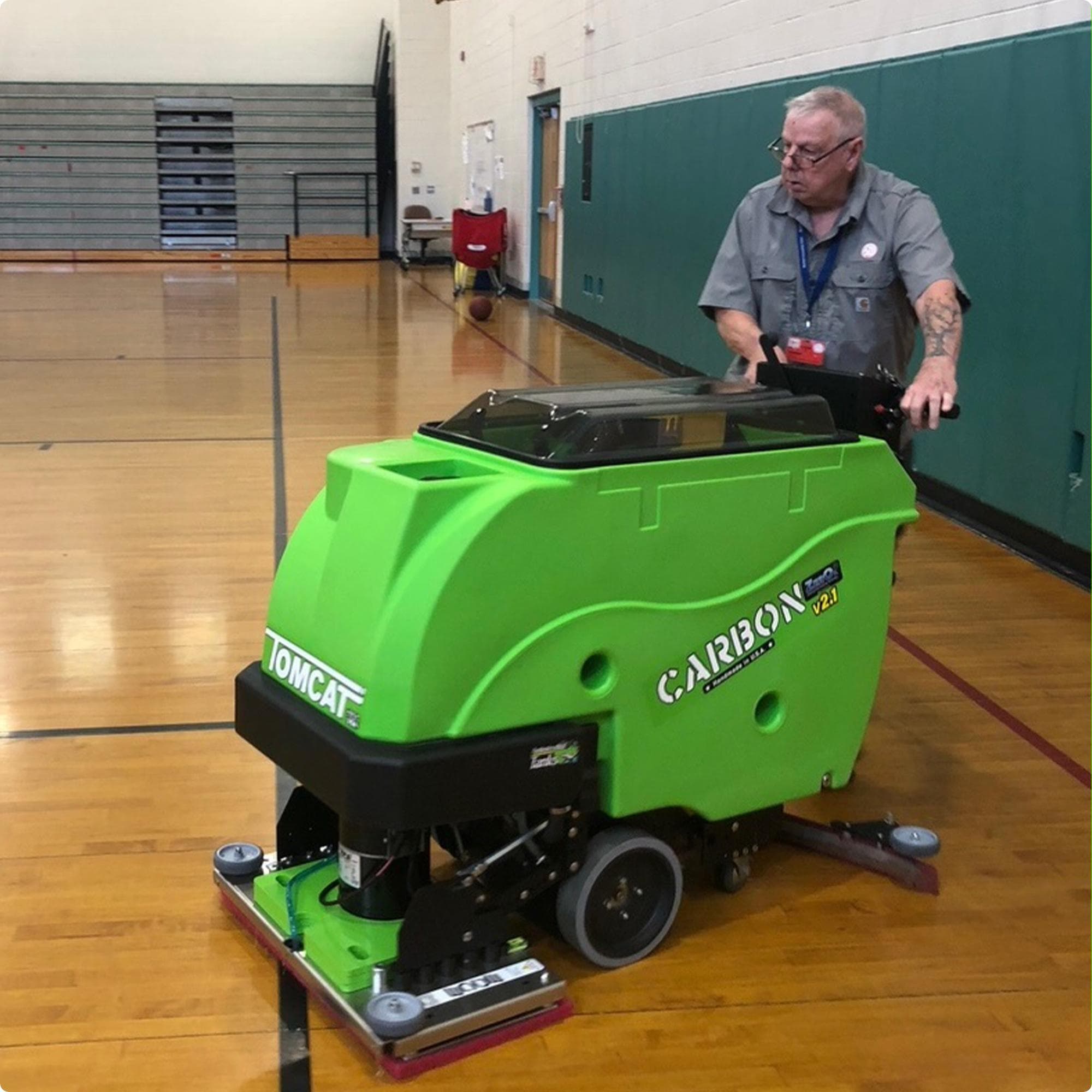 Tomcat Carbon 28" EDGE walk behind  floor scubber with anti-microbial tank option cleaning a wood floor in a gymnasiumIMG0003