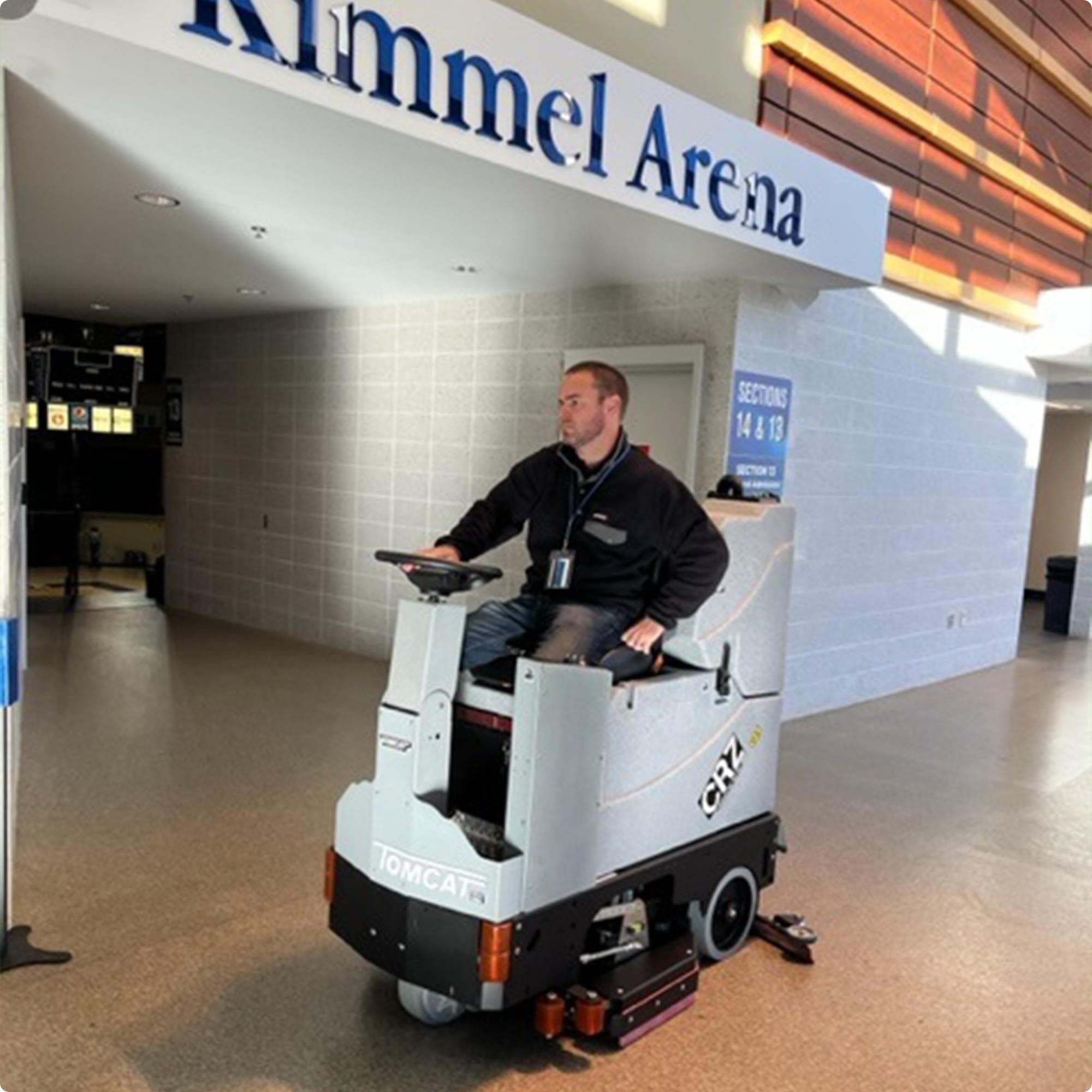 Tomcat CRZ 34" Disk Deck Ride On Floor Scrubber cleaning an epoxy floor in the lobby of an arena IMG00024