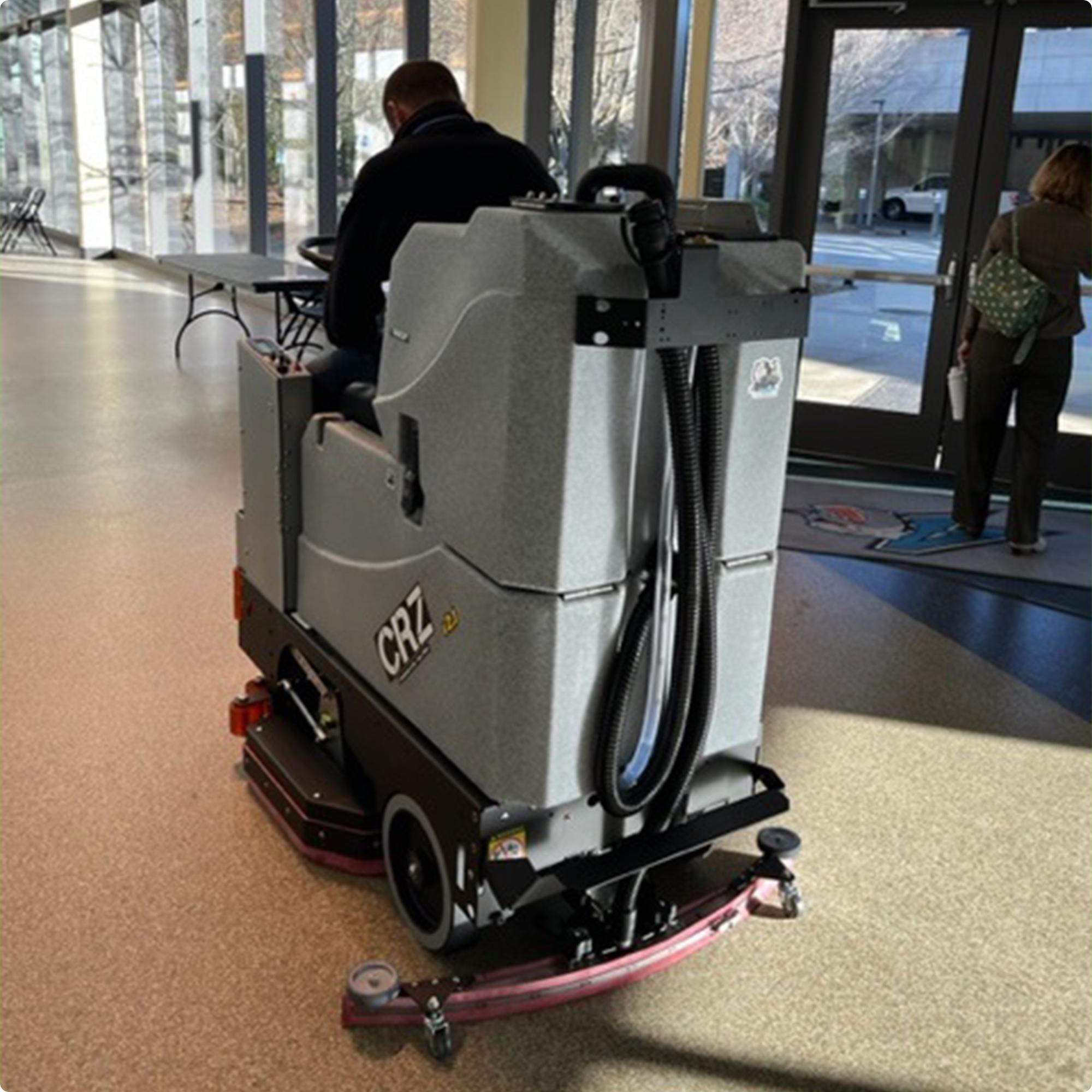 Tomcat CRZ 34" Disk Deck Ride On Floor Scrubber cleaning an epoxy floor in the lobby of an arena IMG00025