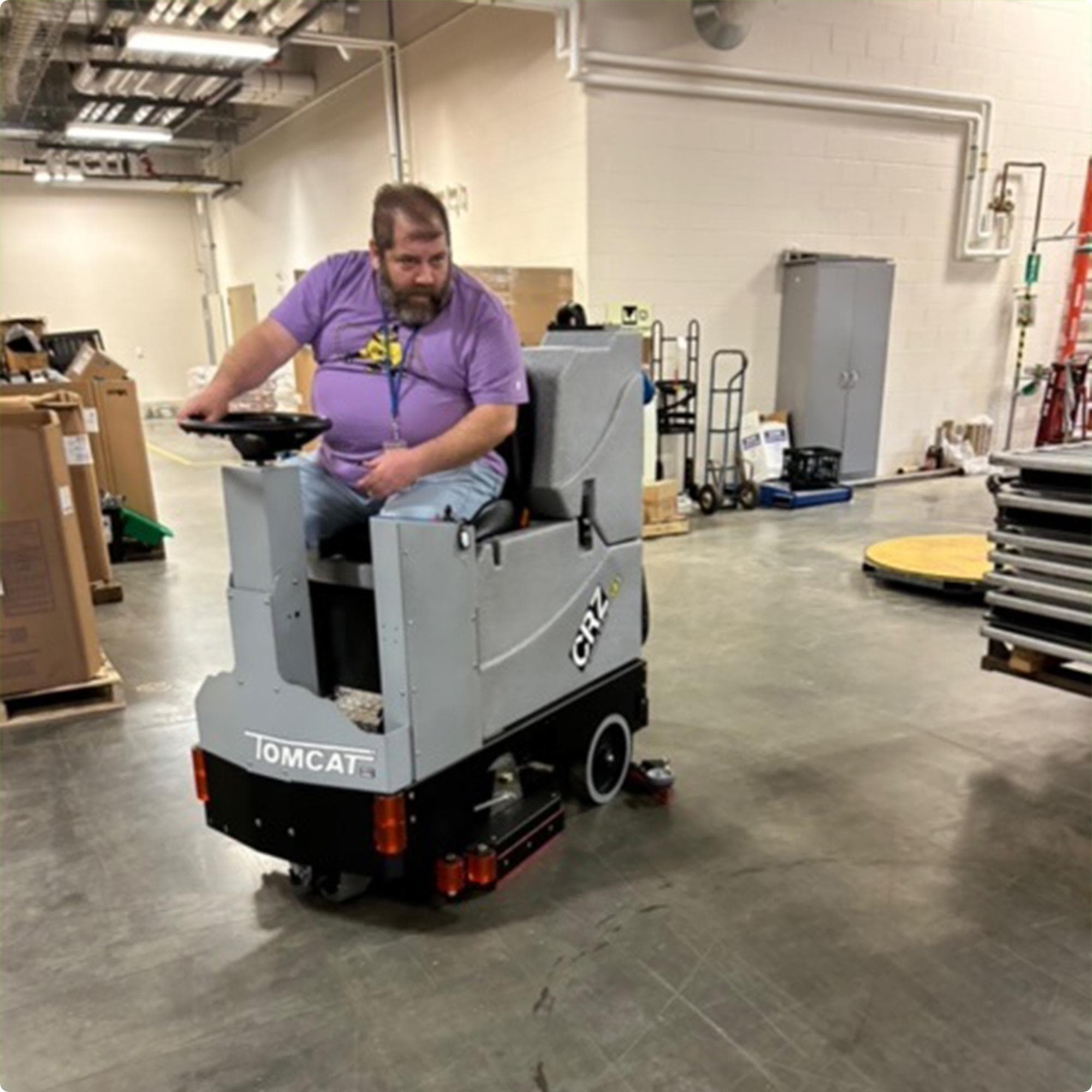 Tomcat CRZ 34" Disk Deck Ride On Floor Scrubber cleaning concrete in the warehouse of a high school IMG00040