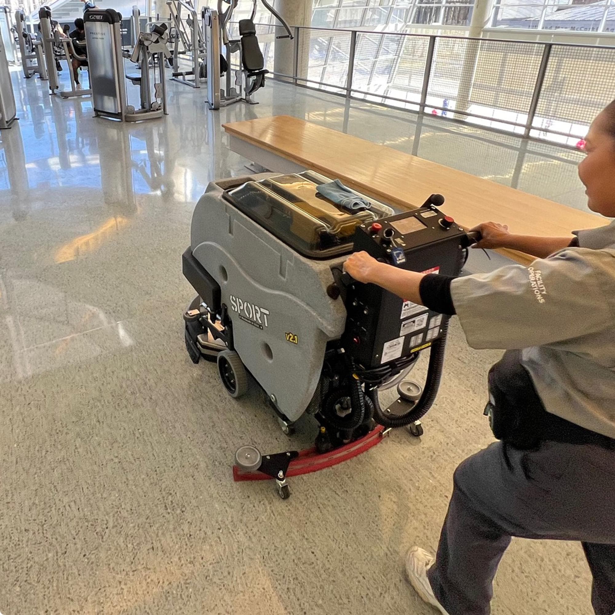 Tomcat SPORT v2.1 20" Disk Deck Floor Scrubber cleaning a terazzo floor in the fitness center of a university IMG00065