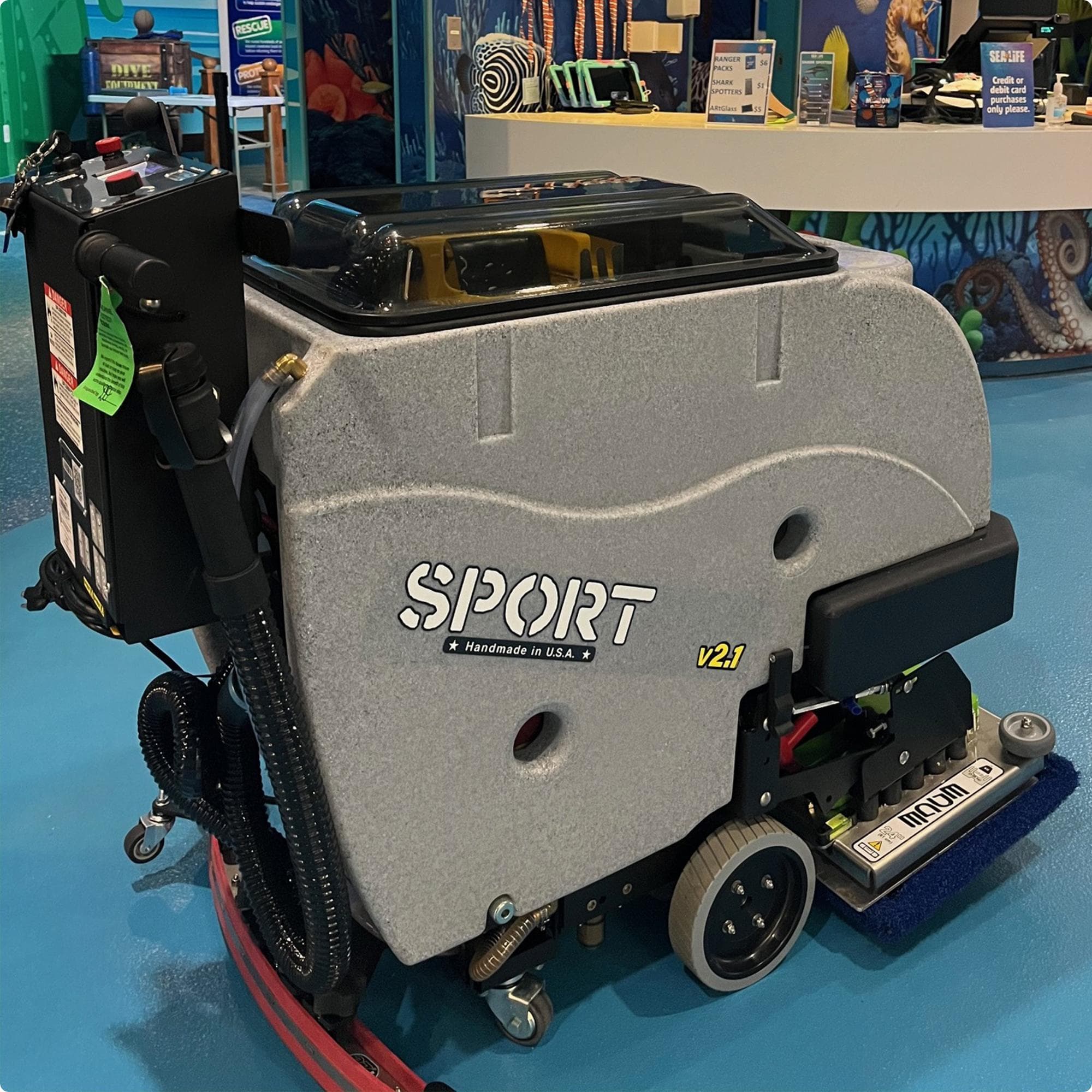 Tomcat Sport 24" EDGE Deck Walk Behind Floor Scrubber cleaning an epoxy floor in the lobby of an aquarium IMG00056