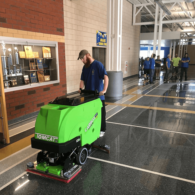 Tomcat floor scrubber showcasing its cleaning power