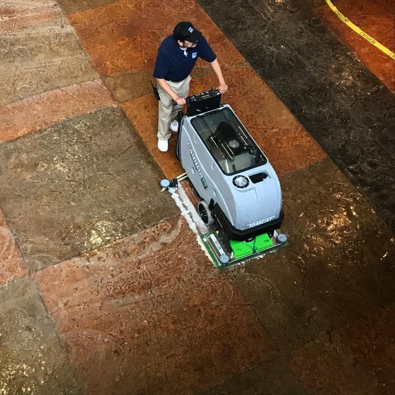 Tomcat Walk Behind Floor Scrubbers Carbon lobby epoxy CARBON Walk Behind Floor Scrubber cleans the epoxy coated stamped concrete in a Las Vegas Casino