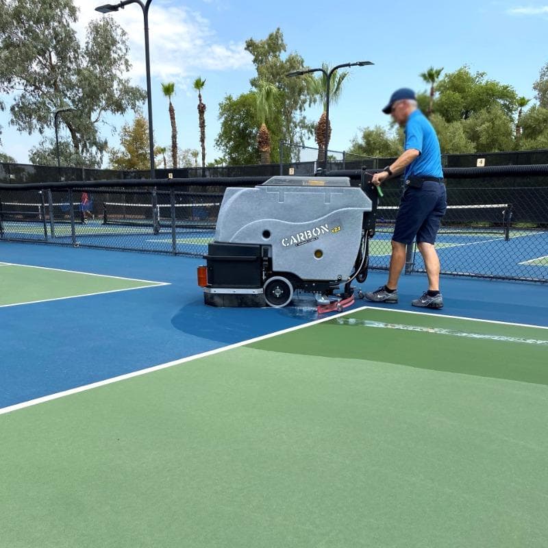 Tomcat Walk Behind Floor Scrubbers Carbon tennis court concrete CARBON Walk Behind Floor Scrubber cleaning the tennis courts at a Dayton, Ohio health club.