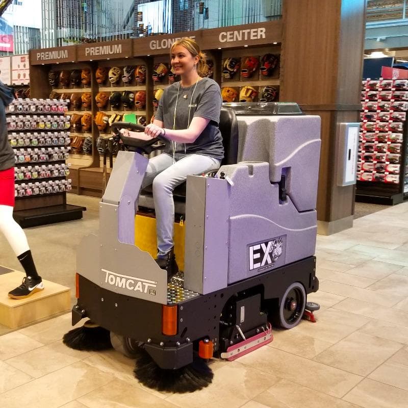 Tomcat Ride On Floor Scrubbers EX sales floor ceramic tile A Tomcat EX ride on floor scrubber cleaning the ceramic tile sales floor of a sporting goods store in Milwaukee, WI