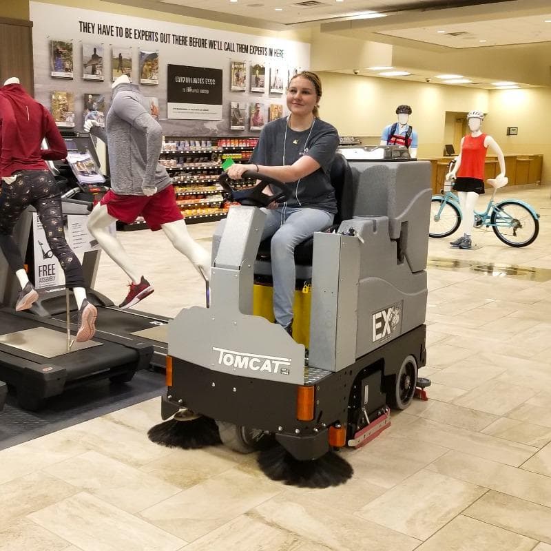 Tomcat Ride On Floor Scrubbers EX sales floor ceramic tile A Tomcat EX ride on floor scrubber cleaning the ceramic tile sales floor of a sporting goods store in Milwaukee, WI