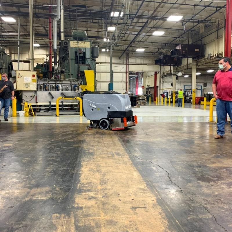Tomcat Walk Behind Floor Scrubbers Hero production areas concrete A Tomcat Hero walk behind floor scrubber cleaning the concrete floor of a production area in Houston, TX.
