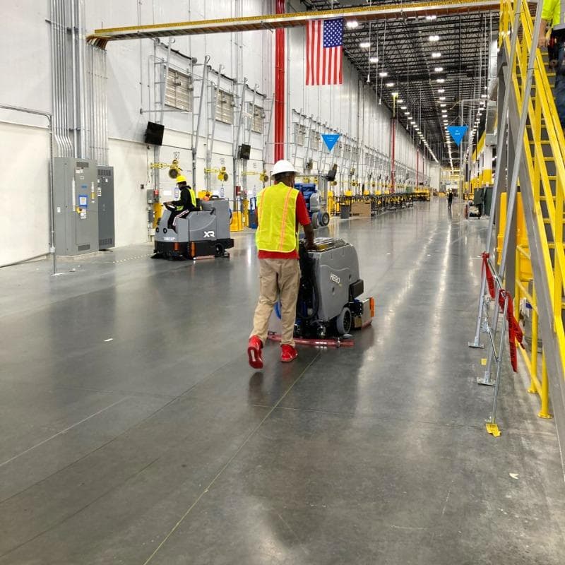 Tomcat Walk Behind Floor Scrubbers Hero production floor concrete HERO Walk Behind Floor Scrubber cleaning the densified concrete floors in the production area of a Salt Lake City, Utah chemical manufacturer