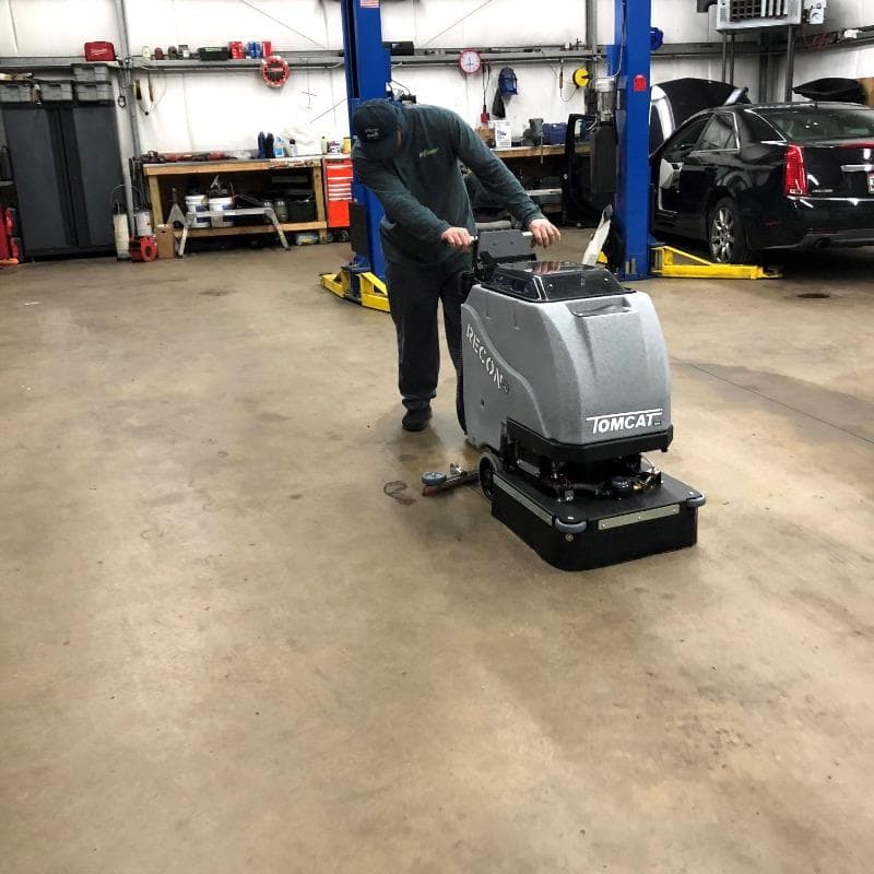 Tomcat Walk Behind Floor Scrubbers Recon service bay concrete A Tomcat Recon walk behind auto scrubber cleaning the concrete service bays of an auto service center in Baltimore, MD