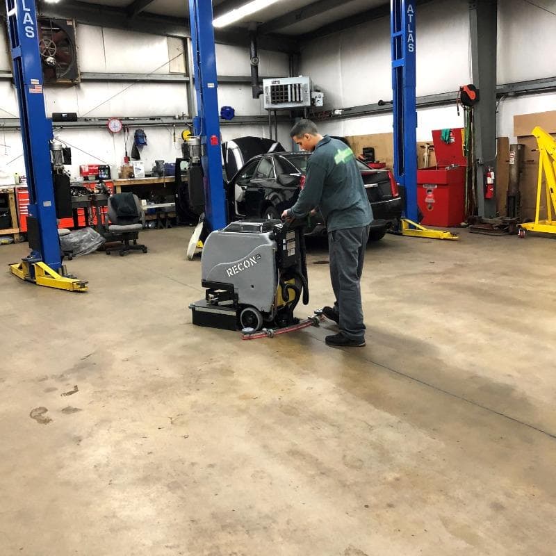 Tomcat Walk Behind Floor Scrubbers Recon service bay concrete A Tomcat Recon walk behind auto scrubber cleaning the concrete service bays of an auto service center in Baltimore, MD