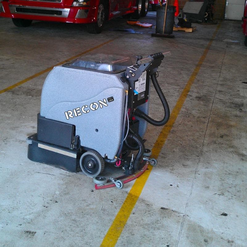 Tomcat Walk Behind Floor Scrubbers Recon service bay epoxy RECON Walk Behind Floor Scrubber cleans a filthy epoxy floor in a service bay of a  Williamsburg, Virginia truck repair shop