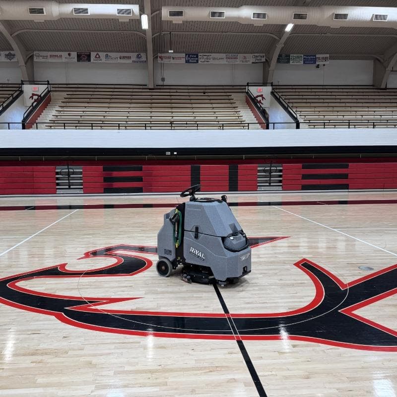 Tomcat Stand On Floor Scrubbers Rival basketball courts wood gym floor A Tomcat Rival stand on battery floor scrubber cleaning the wood gym floor  of a basketball court in Dayton, OH.
