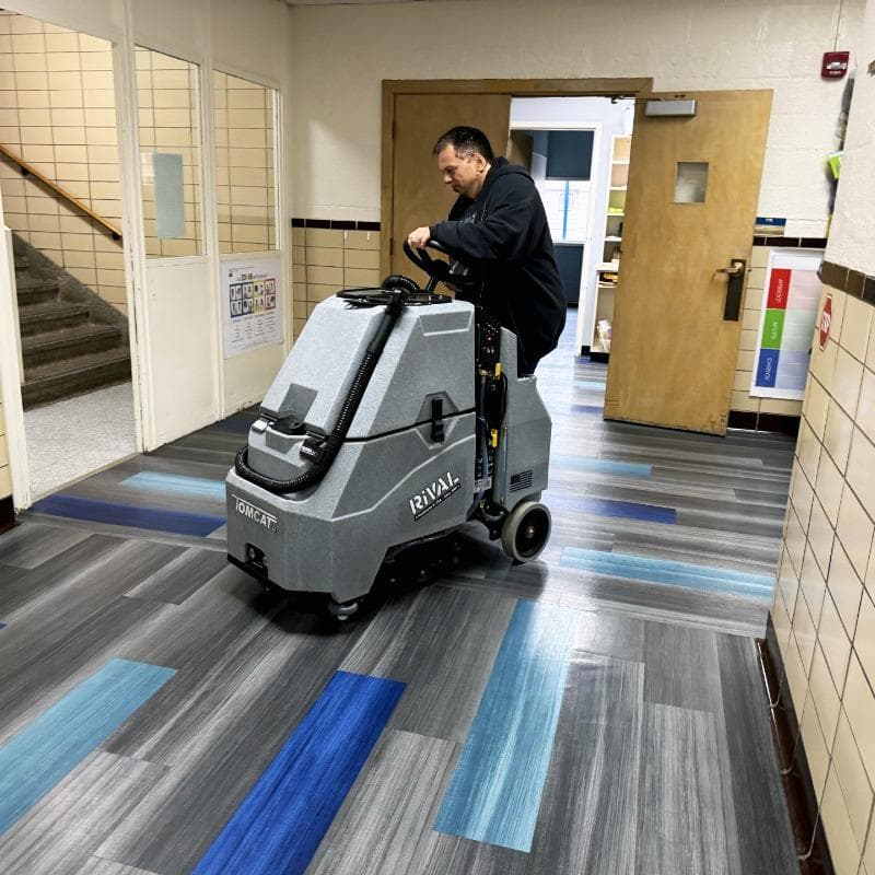Tomcat Stand On Floor Scrubbers Rival halls vinyl floors A Tomcat Rival stand on battery floor scrubber cleaning the vinyl floor of a hall at a university in Lexington, KY