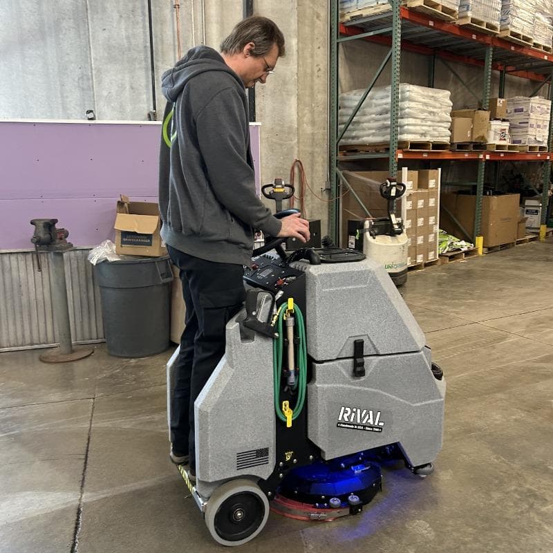 Tomcat Stand On Floor Scrubbers Rival warehouse concrete A Tomcat Rival stand on battery floor scrubber cleaning the Concrete floor of a Warehouse  in Los Angeles, CA