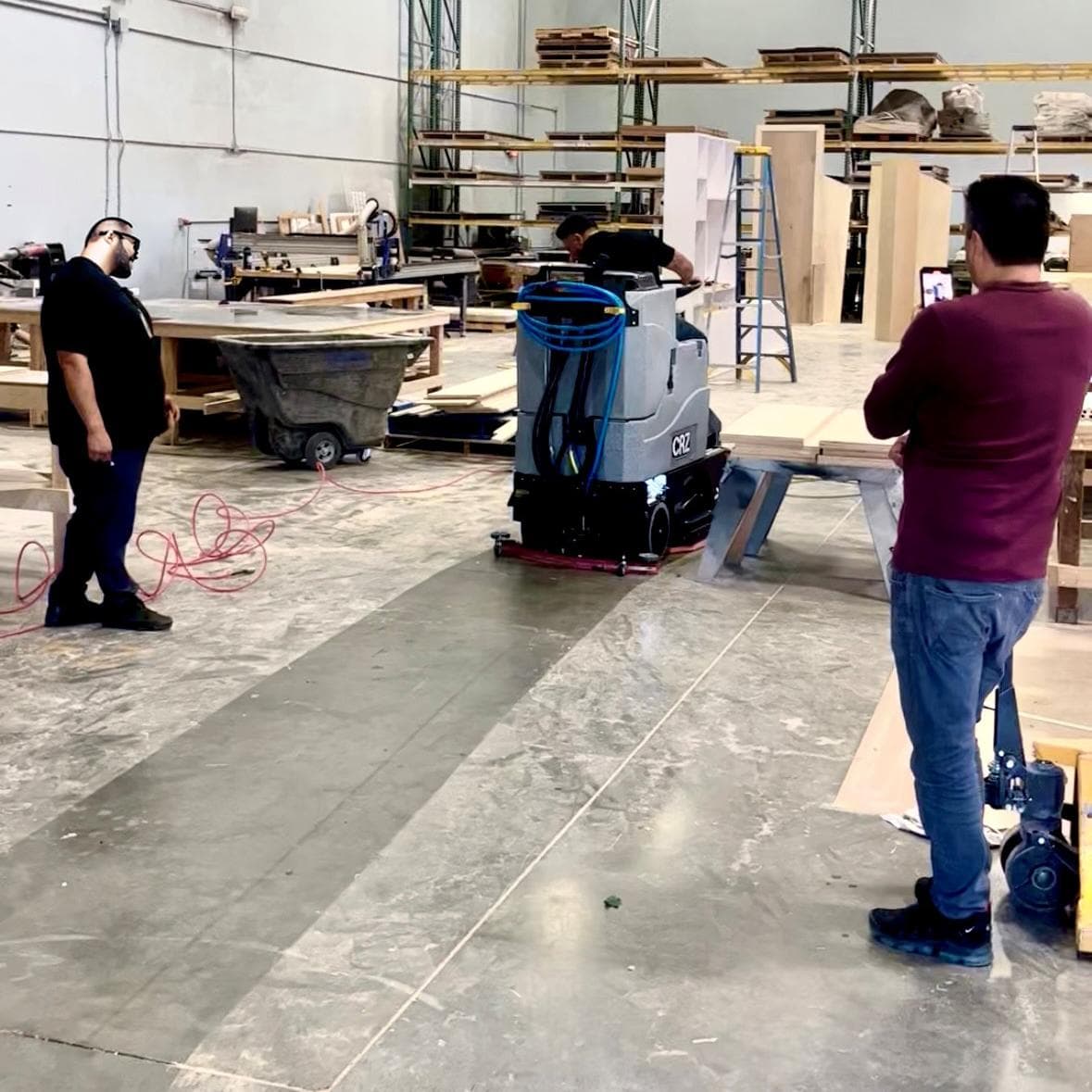 Tomcat Ride On Floor Scrubbers CRZ production floor concrete A Tomcat CRZ ride on auto scrubber cleans the production area of a display manufacturer in California.