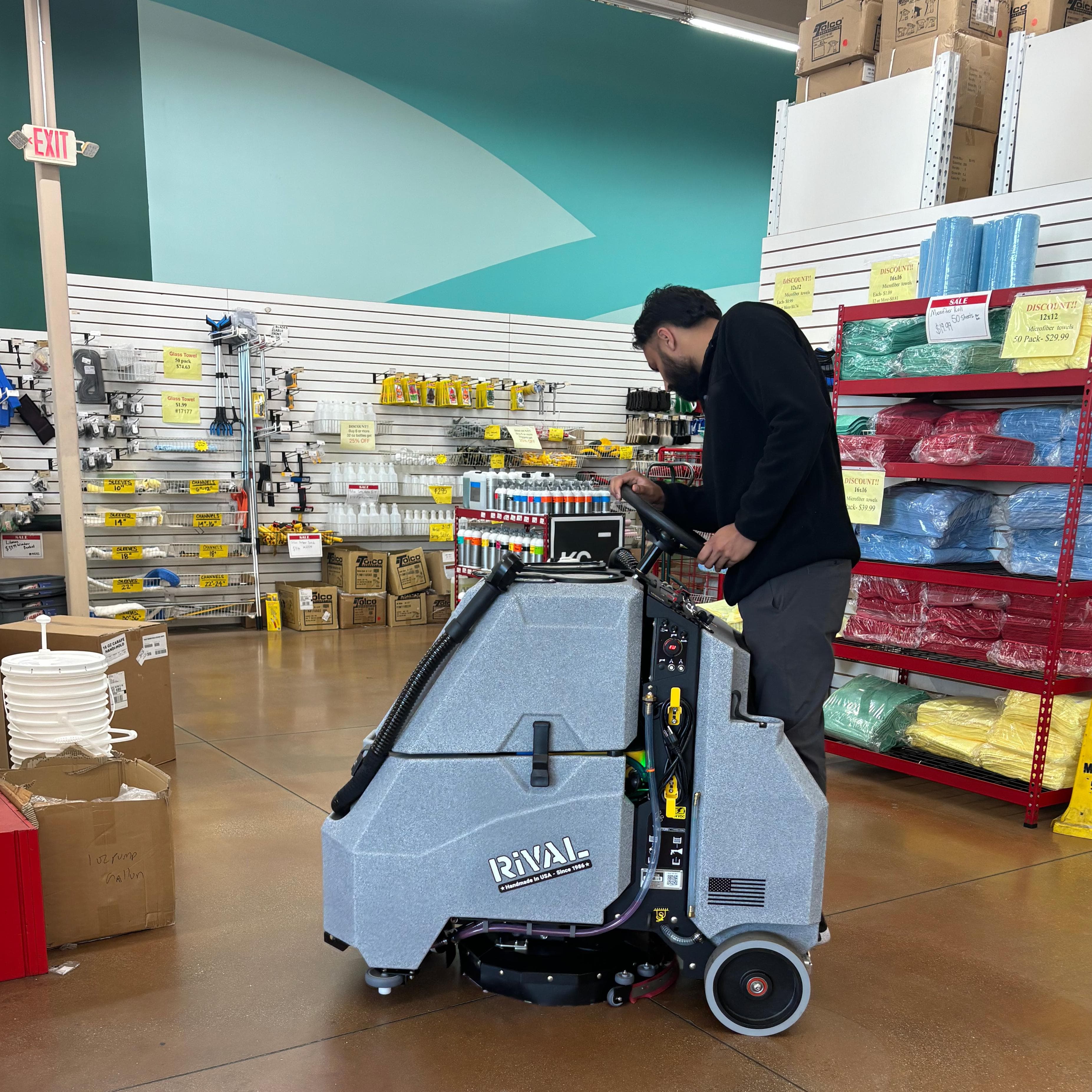 Tomcat Stand On Floor Scrubbers Rival showroom sealed concrete A Tomcat Rival stand-on auto scrubber cleans the sealed concrete floor in a retail showroom in Las Vegas, Nevada.